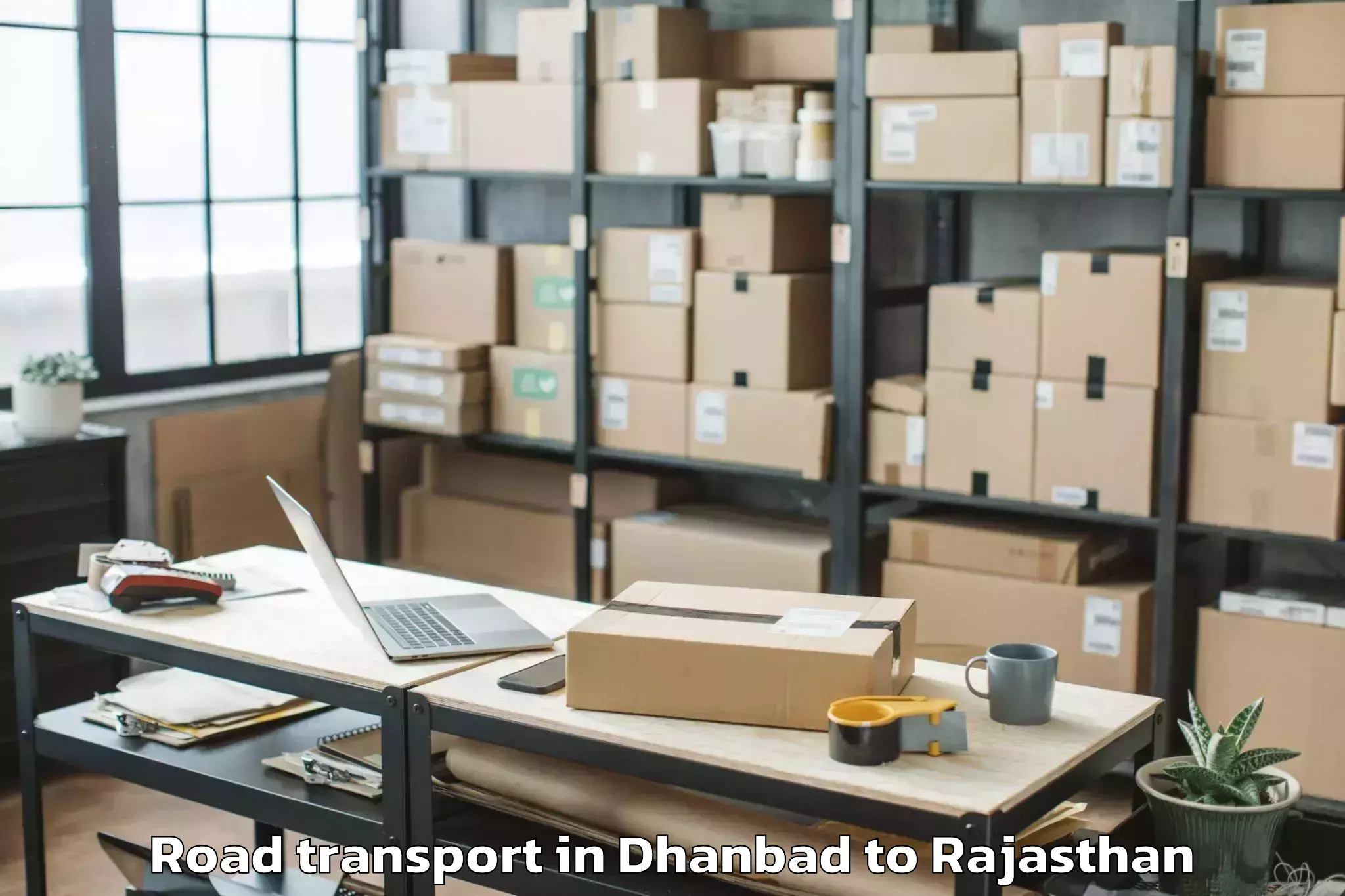 Book Your Dhanbad to Maharaja Ganga Singh Universit Road Transport Today